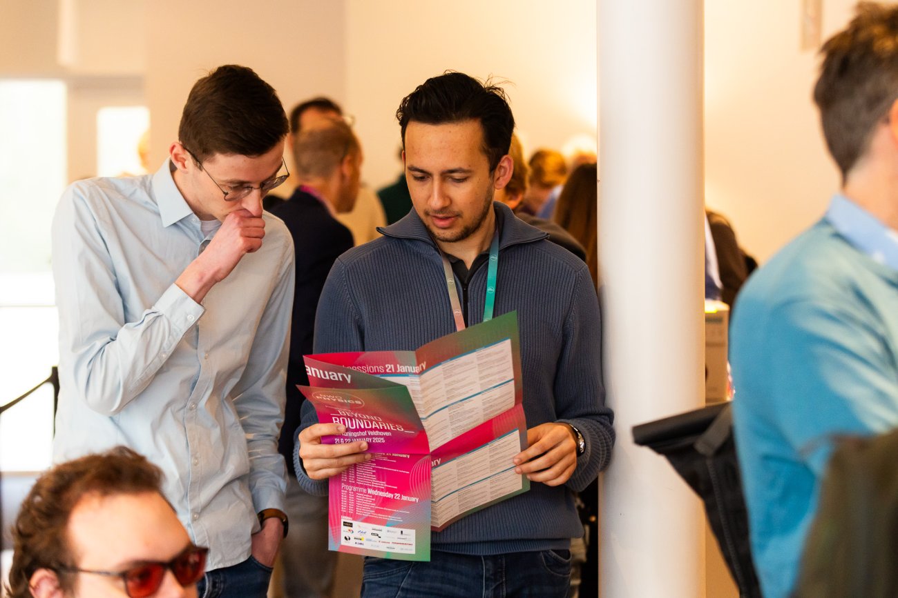 Visitors looking at programme